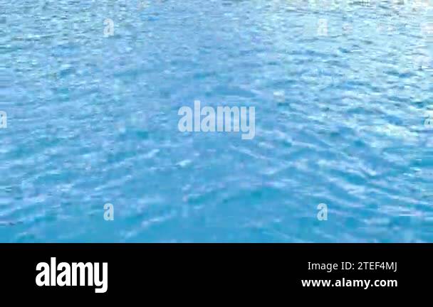 Pure blue water in the swimming pool with light reflections. Water ...