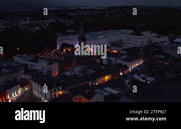 Fly above town development in evening. Aerial footage of historic city