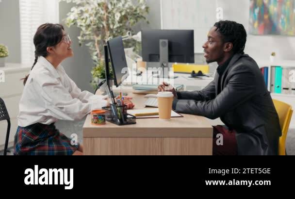 head of company, dark-skinned in suit, talks to candidate for position ...