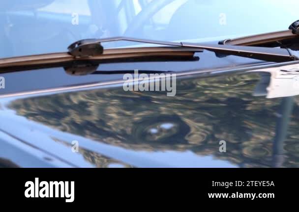 Damaged car engine hood with many hail damage dents show the importance ...