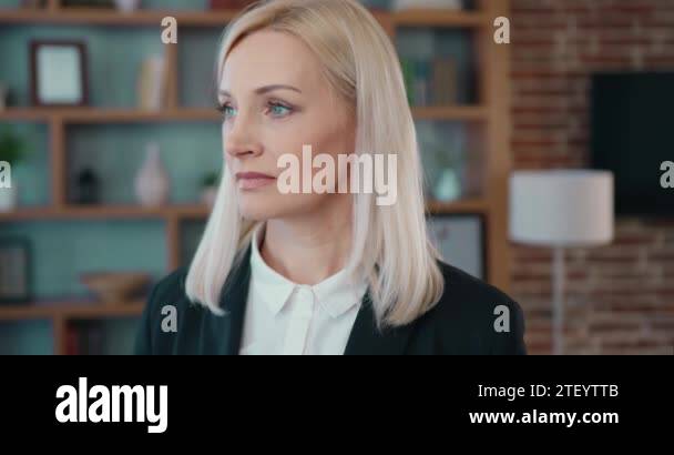 Good-looking dreamy successful light haired female office manager ...