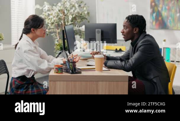 head of company, dark-skinned in suit, talks to candidate for position ...