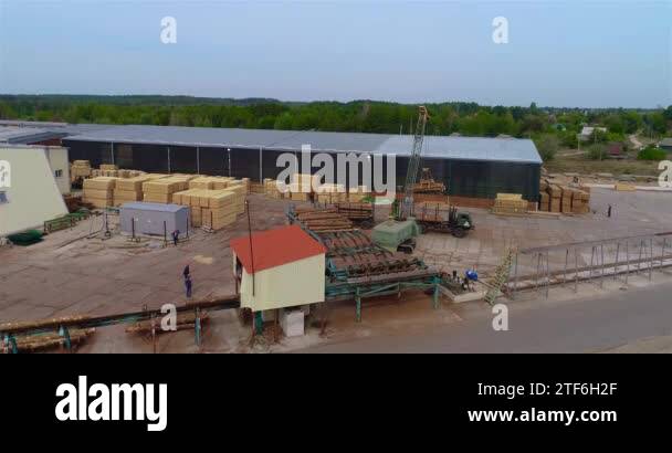 Modern sawmill aerial view, crane unloads logs on the conveyor. General ...