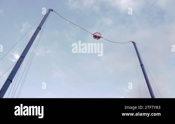 Invistable Flying Rope Extreme flying dangerous attraction. Jumping on rubber ropes. Extreme ...