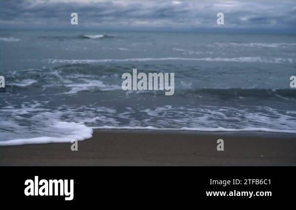 Sea waves crash beach on dark stormy weather ocean coast landscape ...