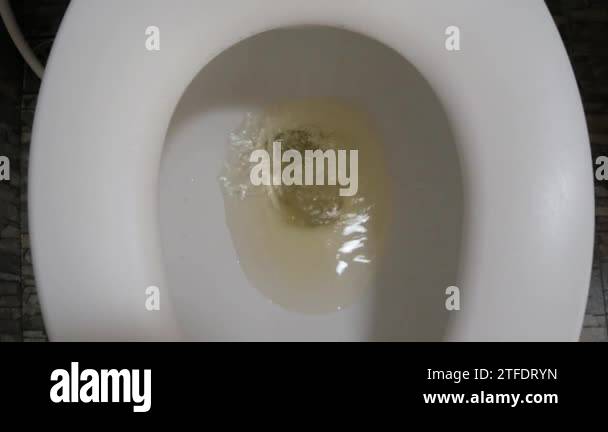 pov-into-the-toilet-bowl-while-flushing-the-shit-feces-with-water-2tfdryn.jpg