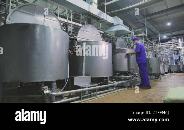 Working process in a food factory. Containers for liquids in a food ...