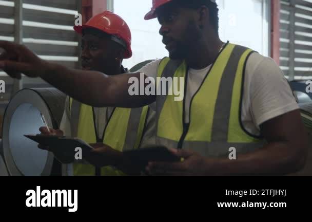 Engineer two worker man African black marking inspection on roll metal ...