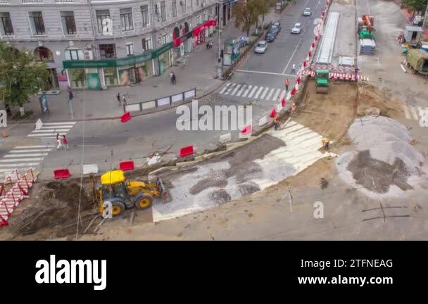 The bulldozer moves and spreads the soil and rubble on the substrate of ...