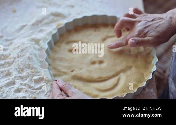 Womens hands with dough. A person prepares homemade pastries from ...