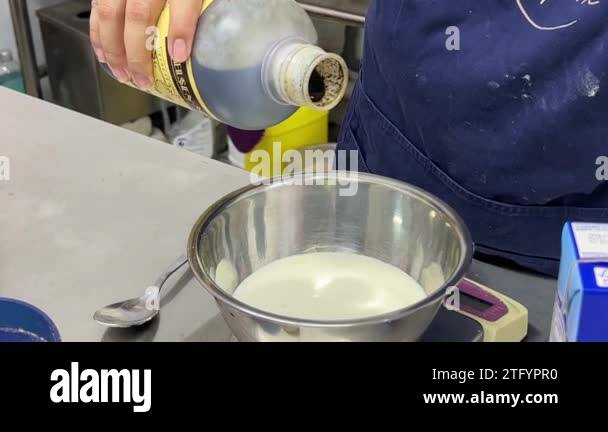 Faceless Pastry Chef Pouring Vanilla Extract Into A Bowl Of Milk And ...