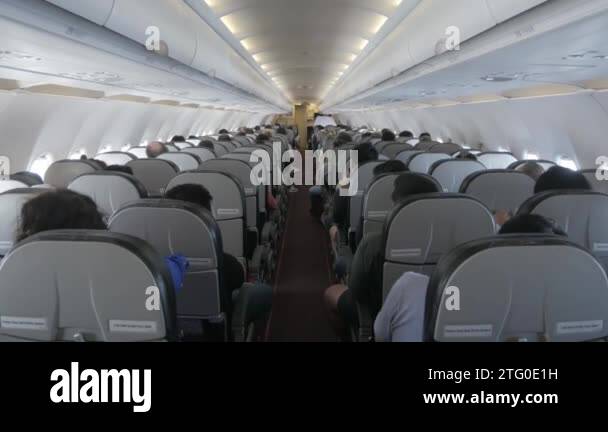 the aisle pathway inside plane cabin with passenger Stock Video Footage ...