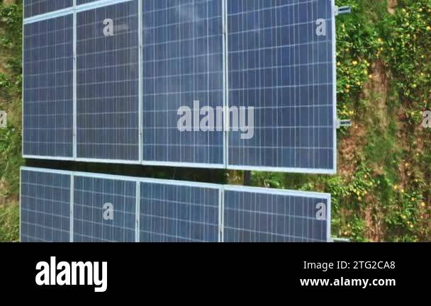 Long row of photovoltaic sun panels built on grass in countryside ...