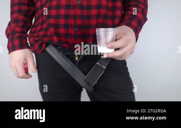 Man takes semen analysis. Spermogram. Concept. Male with his pants ...