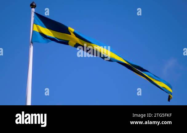 Swedish flags waving with the wind flow under the blue sky for national ...