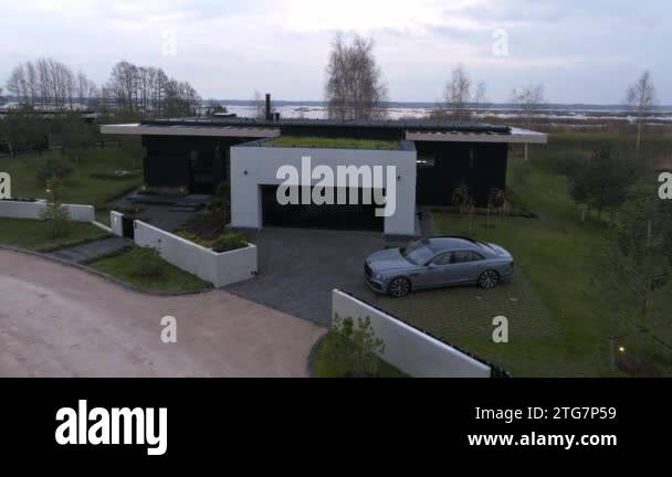 Image showcasing Luxury car parked ny the modern private villa outside the city. Aerial ...