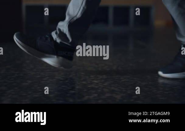 One Leg Student Close up of student legs walking on marble campus floor. Unrecognizable ...