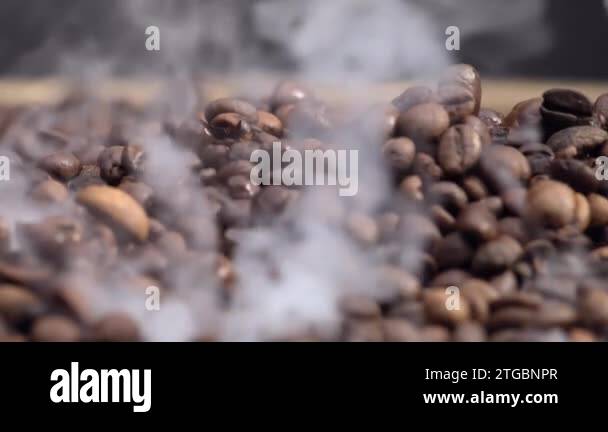 Fragrant coffee beans roasting in super slow motion. Close up of brown ...