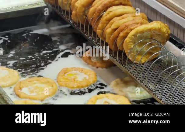 Traditional Hungarian street food Langos at fair. Langos frying in ...