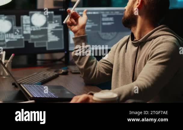 Thoughtful IT engineer brainstorming ideas in office, programming ...