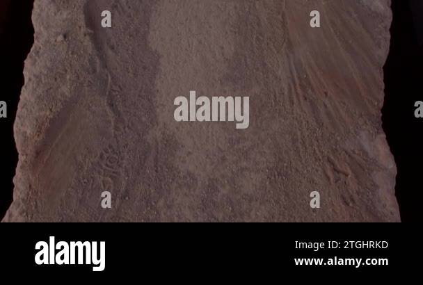 Floor movement in dust, sand and dirt on a dark background. Narrow ...