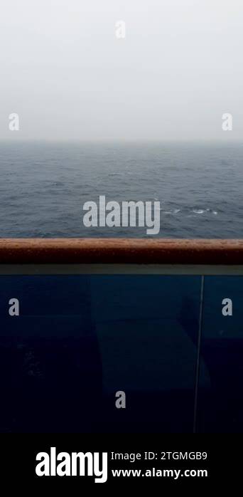 Sea, agitated, being filmed from the cabin of a cruise ship on a rainy ...