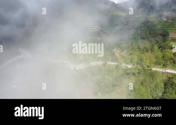An aerial moving drone footage of a curvy road above the gorge with ...