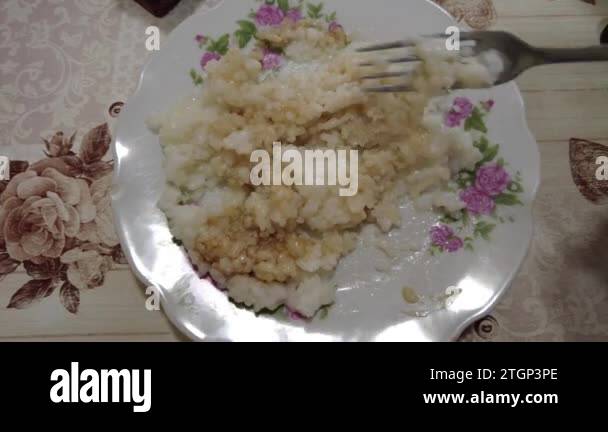 rice porridge on a plate. boiled rice. man eats rice. High quality 4k ...