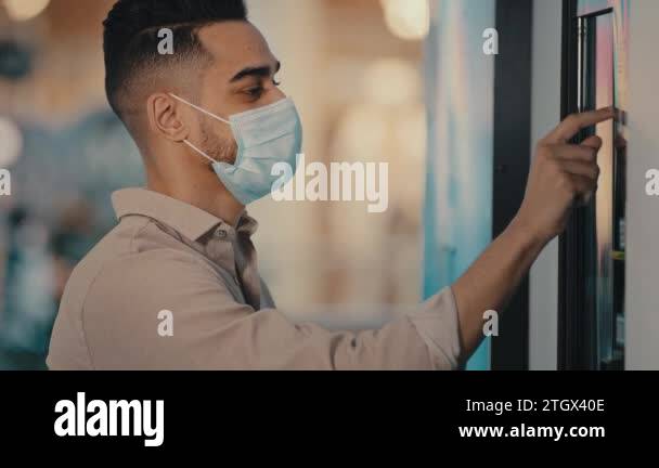 Side view male passenger Indian Hispanic man in medical mask in airport ...