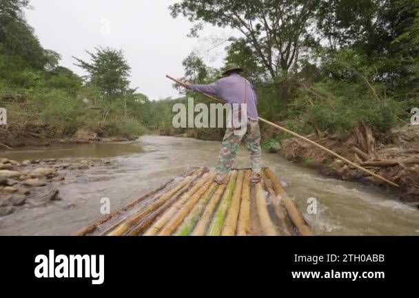 Pushing Raft Chiang Mai, Thailand - 5 December 2022 - Back of a local man on bamboo ...