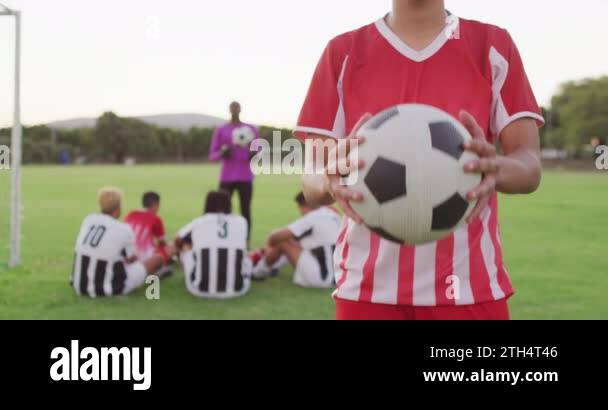 Video of biracial football player on field with ball. Male football ...