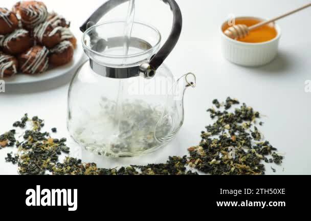 Tea Boiling Process Preparation of chinese green tea - boiling water is poured into a glass ...