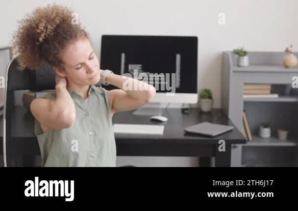 Relax Programmer Waist up slowmo of female programmer stretching her neck to relax after ...
