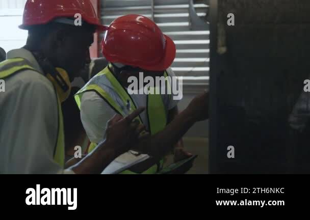 Engineer two worker man African black marking inspection on roll metal ...