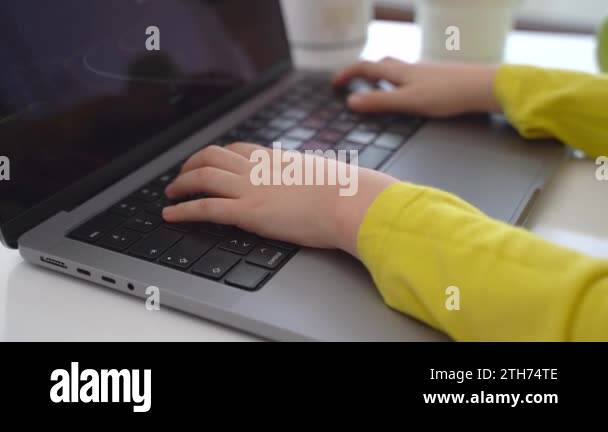 Close up Schoolboy child hands typing keyboard using laptop online ...