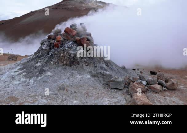 Steam emitting from fumarole in geothermal area of Hverir. Sulphur ...