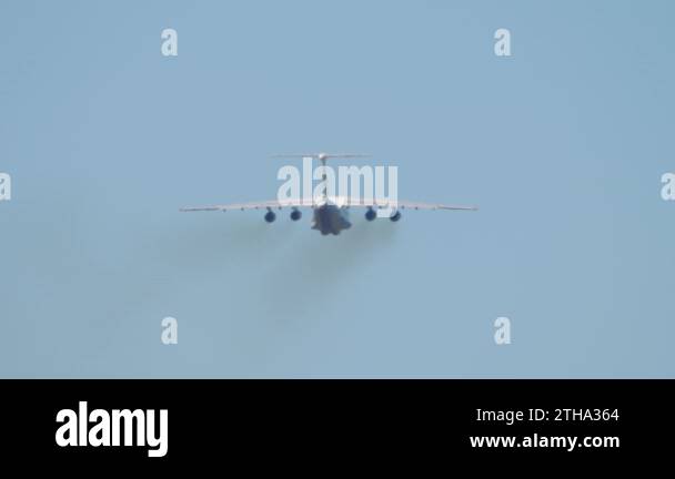 Heavy transport four-engine aircraft climb after takeoff, rear view ...