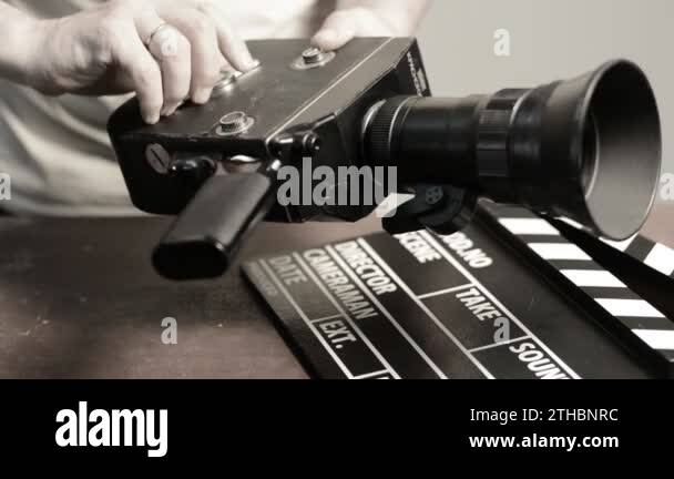 Man gets a spring mechanism on a retro movie camera Stock Video Footage ...