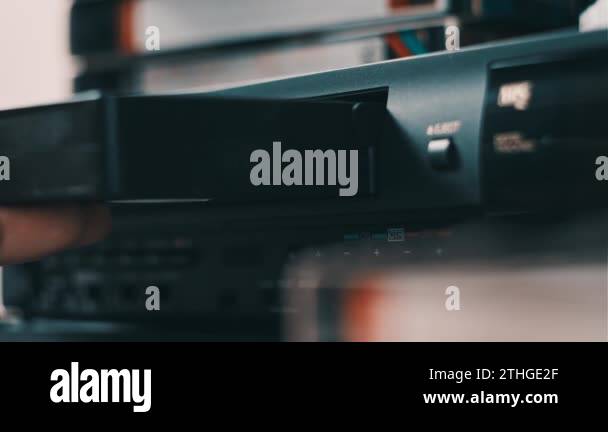Insert VHS cassette into VCR player. Black vintage videotape cassette ...