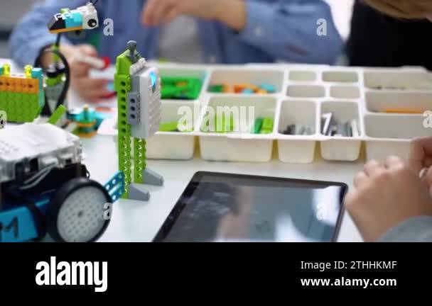 Robotics programming class. Children construct and code Robot. STEM ...