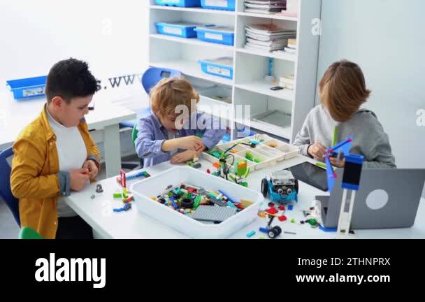Robotics programming class. Children construct and code Robot. STEM ...