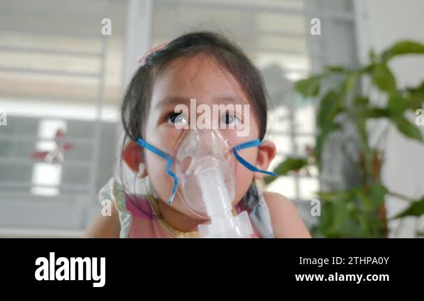 Kid girl making makes inhalation nebulizer steam sick cough at home ...