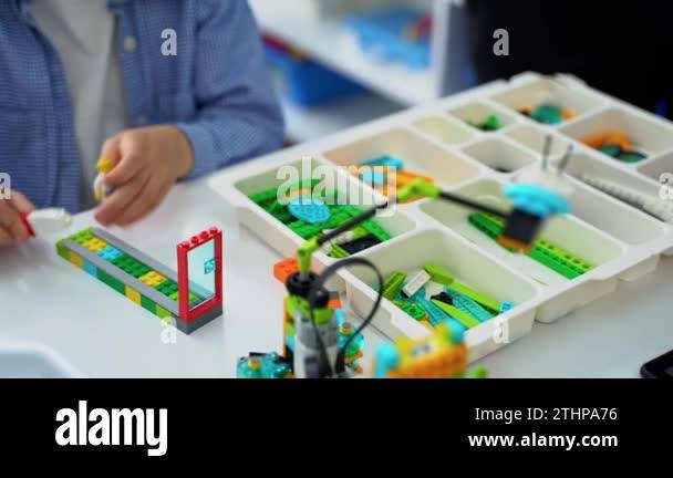 Robotics programming class. Children construct and code Robot. STEM ...