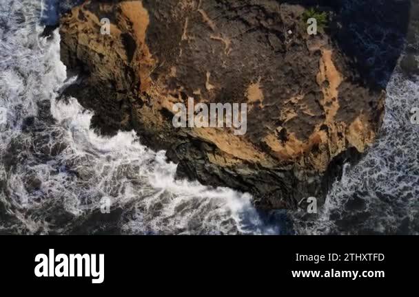 Cenital reveal shot of rocks at the Pacific Ocean along PCH in Big Sur ...