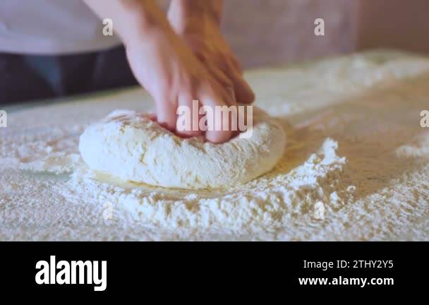 Close Up Making dough by female hands at bakery. shot of hands of woman ...
