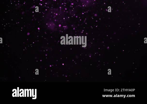 Purple particles falling slowly from left to right over a black ...