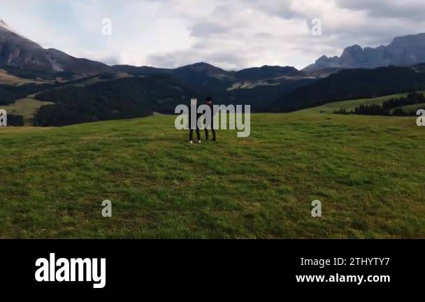 Two men admire the mountains, they sit next to each other and look at ...