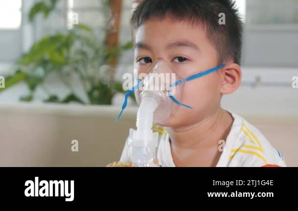 Asian Child using nebulizer mask equipment alone have smoke, Kid boy ...
