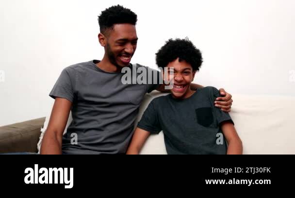 Two brothers relationship laughing and smiling together. Older and ...