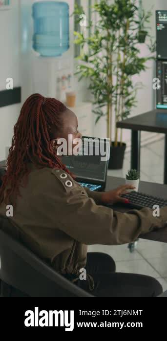 Vertical video: African american programer typing source code on ...